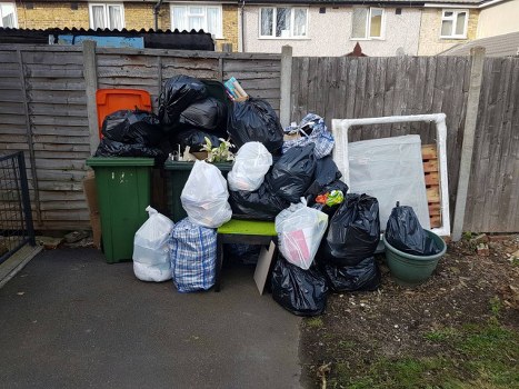 Man and van team loading awkward items in a terraced house